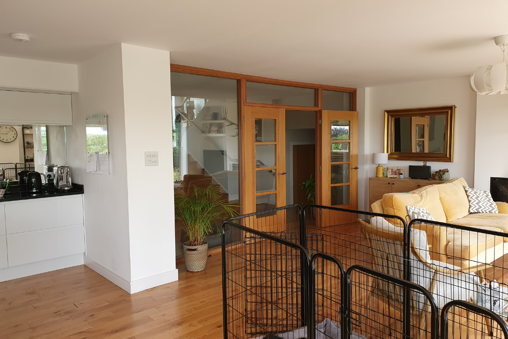 Kitchen before renovation featuring oak double doors and matching oak flooring, prior to redesign by Ivywell Interiors.