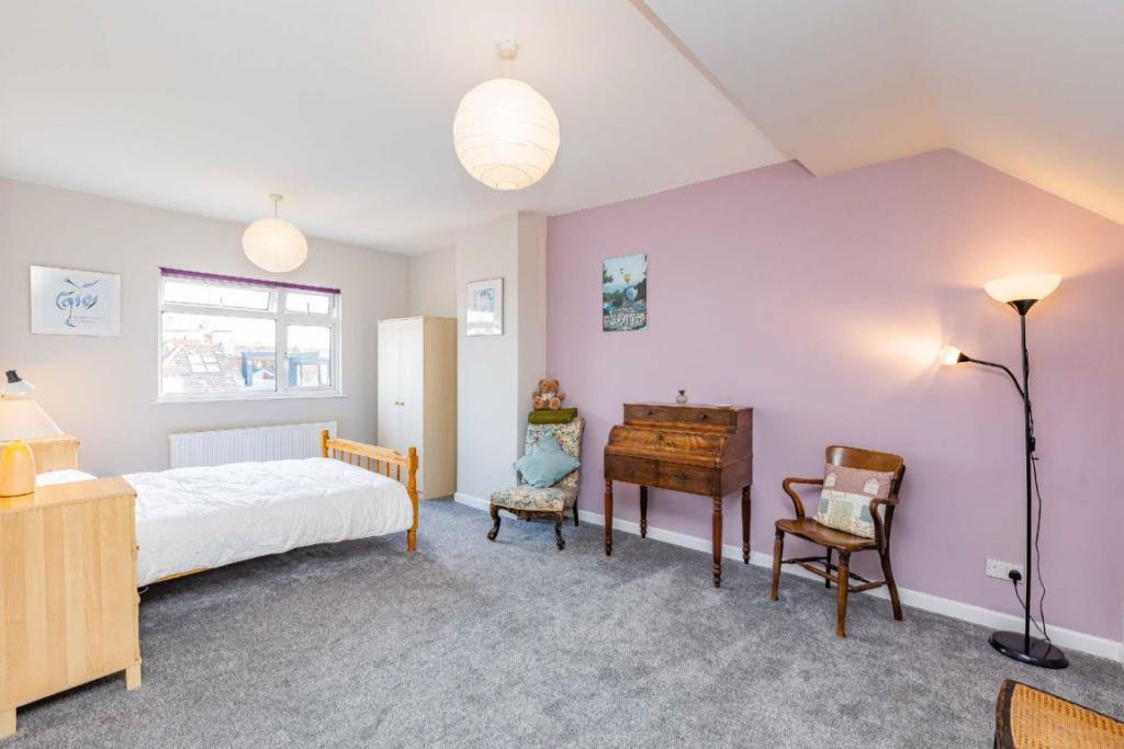 Master bedroom with minimal storage and dated decor prior to loft redesign by Ivywell Interiors in a Bishopston Victorian home.