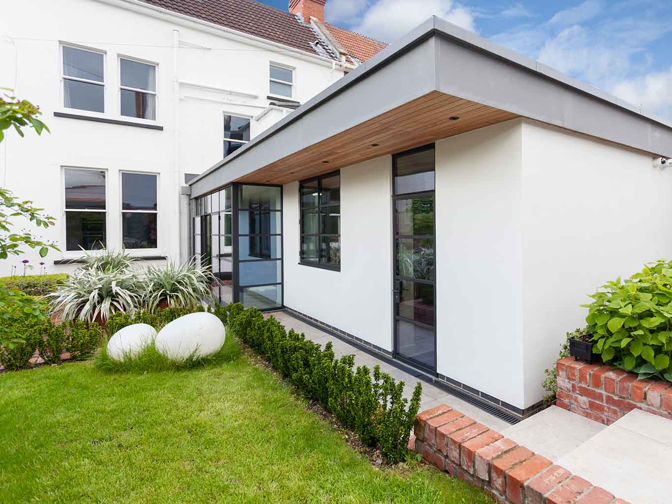 Rear exterior of a Westbury-on-Trym home after extension – modernised brick façade with large glazing