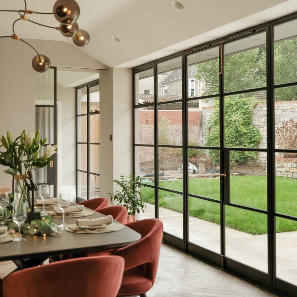 Dining rom featuring large crittall style heritage steeel doors, part of a Victorian home renovation & extension by Ivywell Interiors